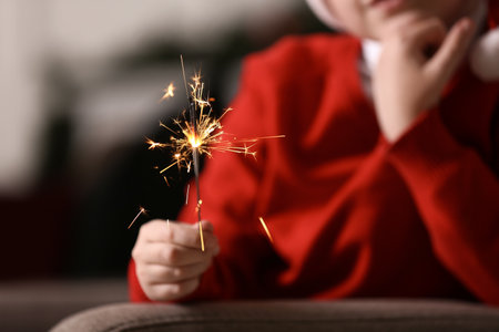 Little boy with Christmas sparklers at home, closeupの写真素材