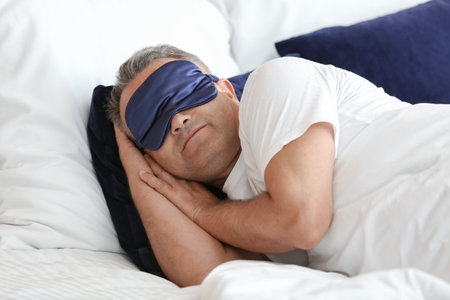 mature man sleeping in bedの写真素材