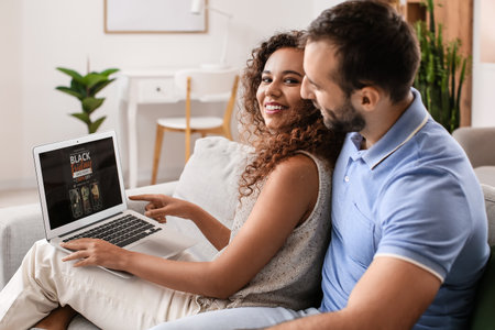 Couple shopping online on Black Friday at homeの写真素材