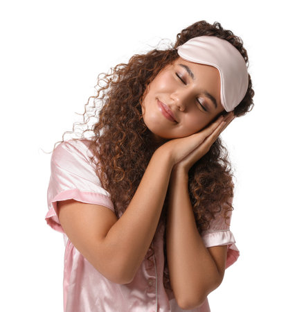 Young African-American woman with pink sleeping mask on white backgroundの写真素材