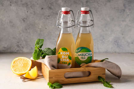 Wooden box with bottles of natural kombucha on tableの写真素材