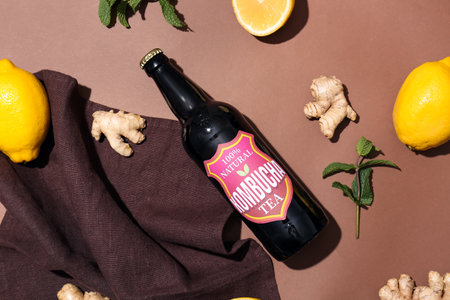 Composition with bottle of fresh kombucha and ingredients on color backgroundの写真素材