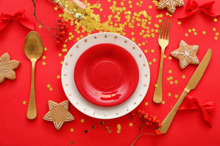 Stylish Christmas table setting on red backgroundの写真素材