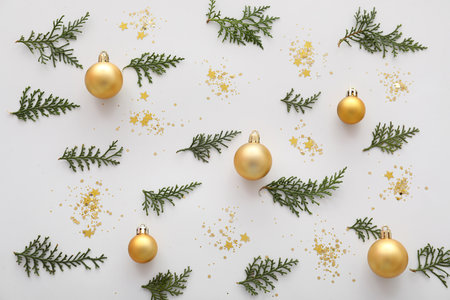 Composition with beautiful Christmas decorations and thuja branches on white background