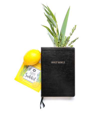 Sukkot festival symbols, greeting card and Bible on white background