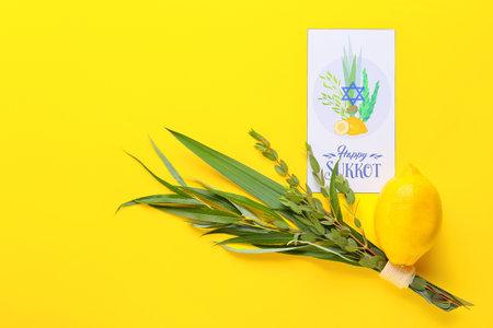 Sukkot festival symbols and greeting card on color background