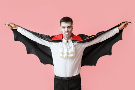Man dressed as vampire for Halloween on color backgroundの写真素材