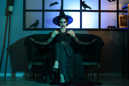 Young woman dressed for Halloween in dark roomの写真素材