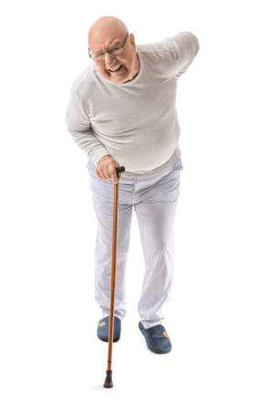 Senior man with walking stick suffering from back pain on white backgroundの写真素材