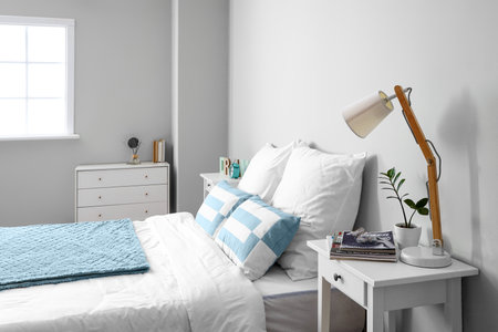 Comfortable bed with table in the interior of the room