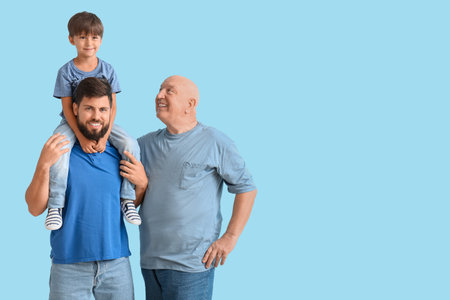 Happy man, his little son and father on color background