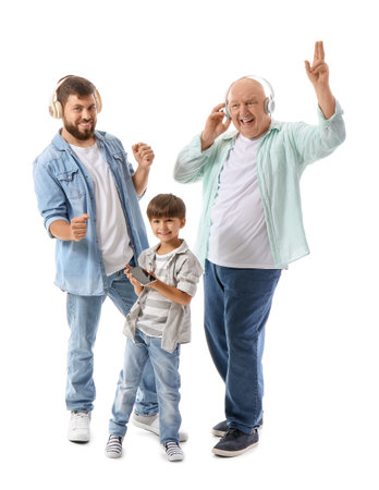 Happy man, his little son and father listening to music and dancing on white backgroundの写真素材