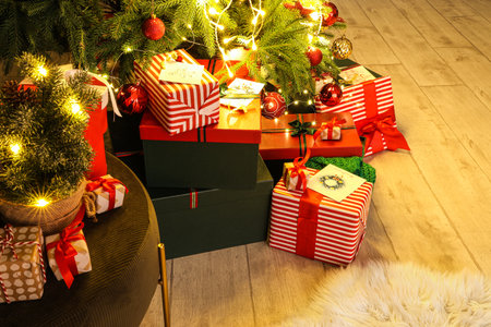 Many gifts under Christmas tree in roomの写真素材