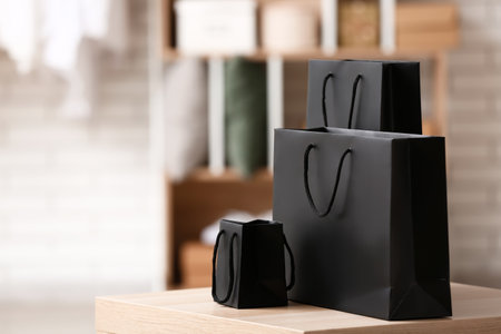 Shopping bags on table in store. black friday saleの写真素材