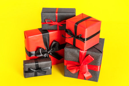 Beautiful gift boxes on yellow background. black friday sale