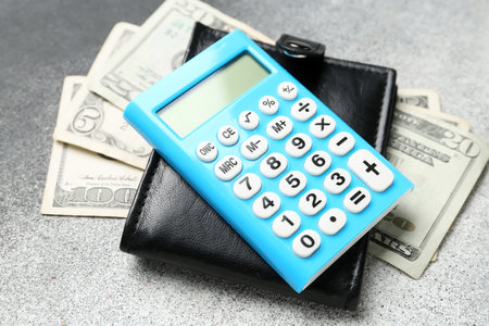 Calculator and wallet with money on white background. budget conceptの写真素材