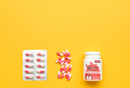 Cranberry pills on color background