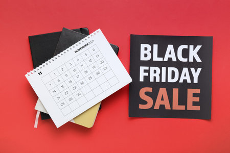 Calendar page of November 2022 and notebooks on color background. Black Fridayの写真素材