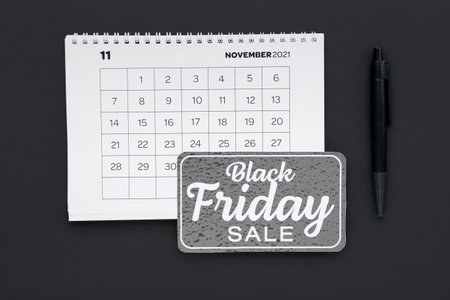Calendar page of November 2022 and pen on dark background. Black Fridayの写真素材