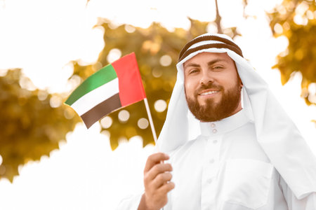 Handsome Muslim man with UAE flag outdoorsの写真素材