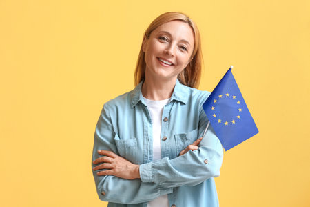 Mature woman with flag of European Union on color backgroundの写真素材