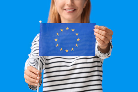 Mature woman with flag of European Union on color background