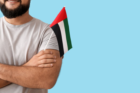 Man with the national flag of UAE on color backgroundの写真素材