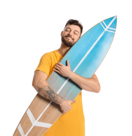Handsome bearded man hugging surfboard on white background