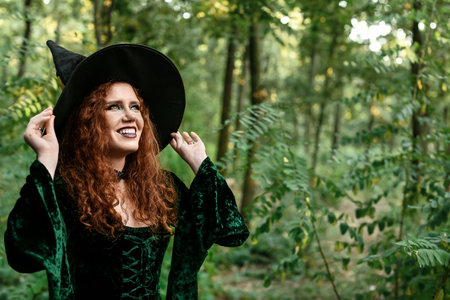 young witch in green forestの写真素材