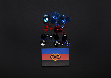 Polyamory flag and sequins on black background