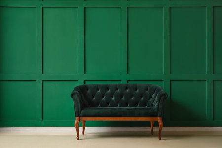 Stylish sofa near green wallの写真素材