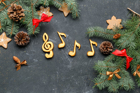 Note signs with Christmas branches, pine cones and cookies on dark backgroundの写真素材