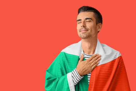 Young man with Italian flag on color backgroundの写真素材