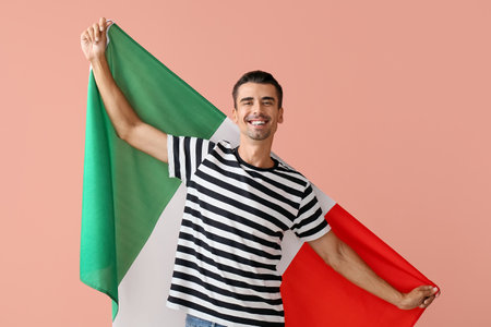 Young man with Italian flag on color backgroundの写真素材