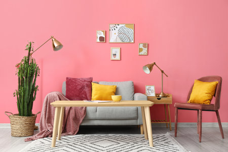 Interior of stylish room with big cactus and sofa