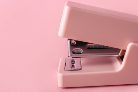 Office stapler on pink background, closeupの写真素材