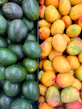Tasty avocados and mangoes as backgroundの写真素材