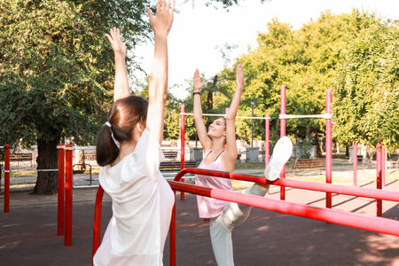 Sporty young women exercising on sport groundの写真素材