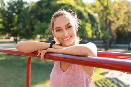 Smiling young woman on sport ground, closeup