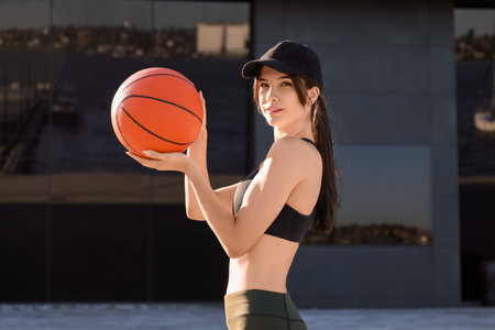 Sporty young woman with cap and ball outdoorsの写真素材