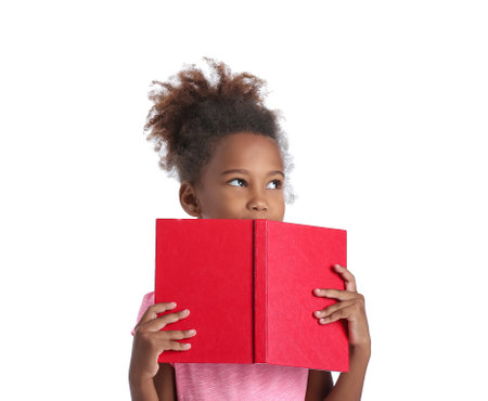 Little African-American girl with book on white backgroundの写真素材