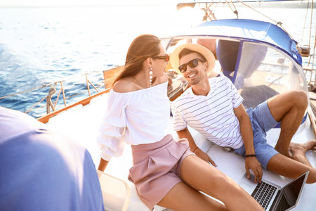Happy young couple resting on yachtの写真素材