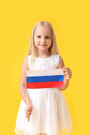 Cute little girl with national flag of Russia on color backgroundの写真素材