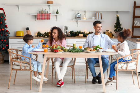 Happy family having Christmas dinner in the kitchenの写真素材