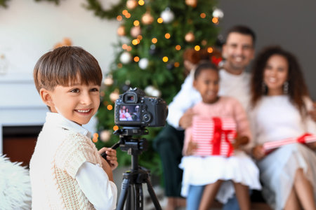 Little boy taking photo of his family at home on Christmas eve
