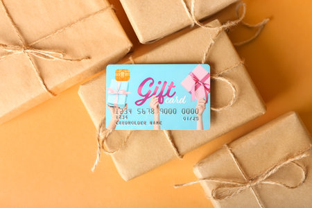 Gift card with Christmas presents on beige background