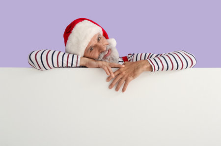 Santa Claus with blank poster on color backgroundの写真素材