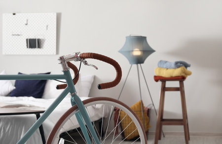 Bicycle in light bedroom interior, closeupの写真素材