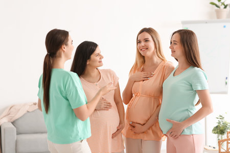 Young pregnant women talking at course for expectant mothersの写真素材
