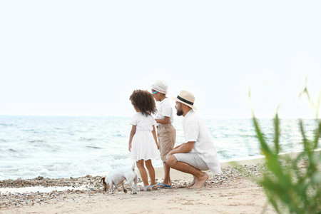 Little children with father on sea beachの写真素材